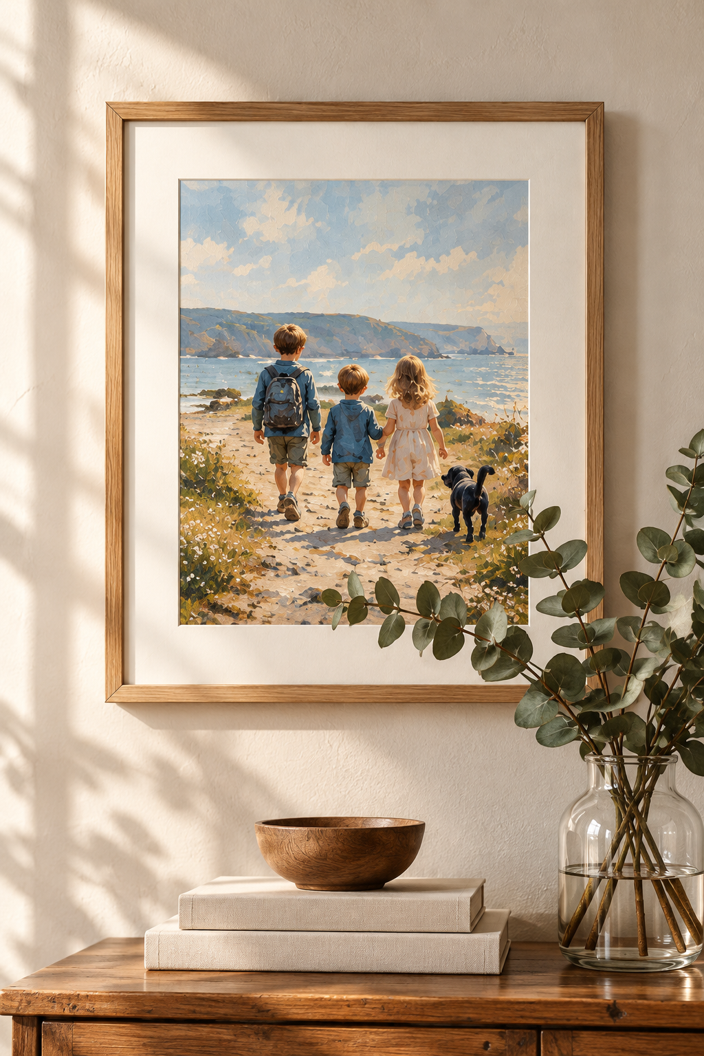 Illustrative framed artwork of children walking beside the sea, displayed on a warm neutral wall